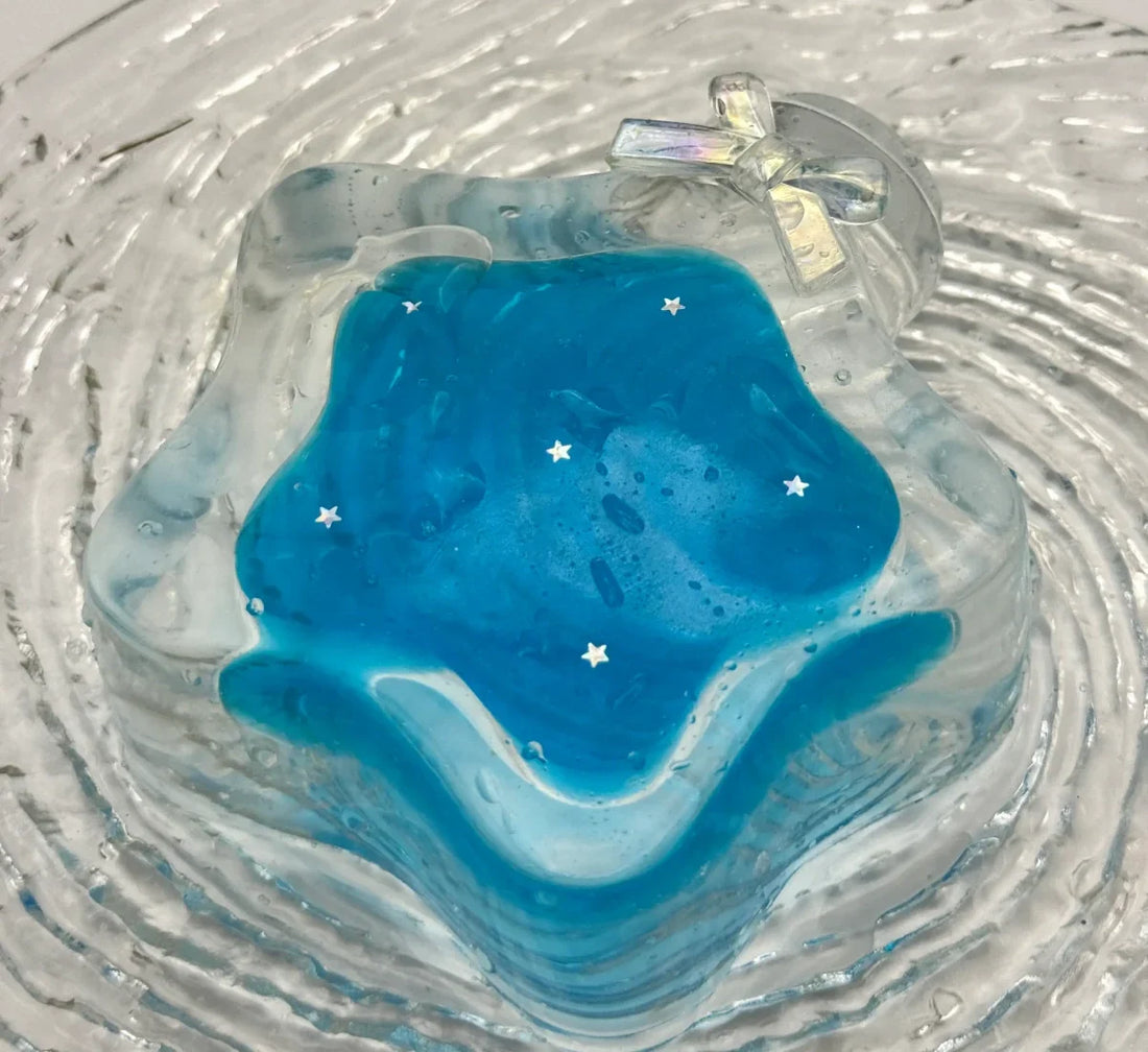 Clear silicone bottle-shaped squishy with blue interior, white star accents - lovesquishy handmade stress-relief toy