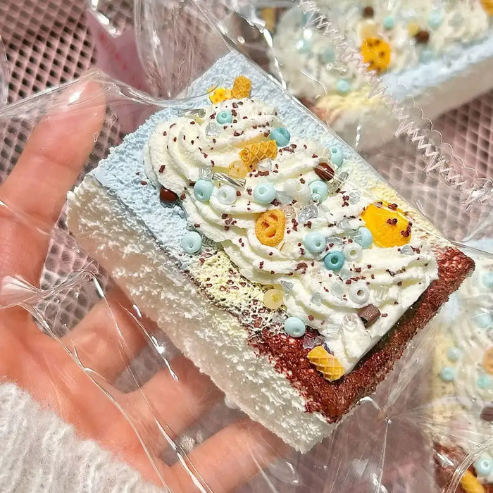 Cream-topped cocoa toast squishy with pastel decorations in a clear pouch